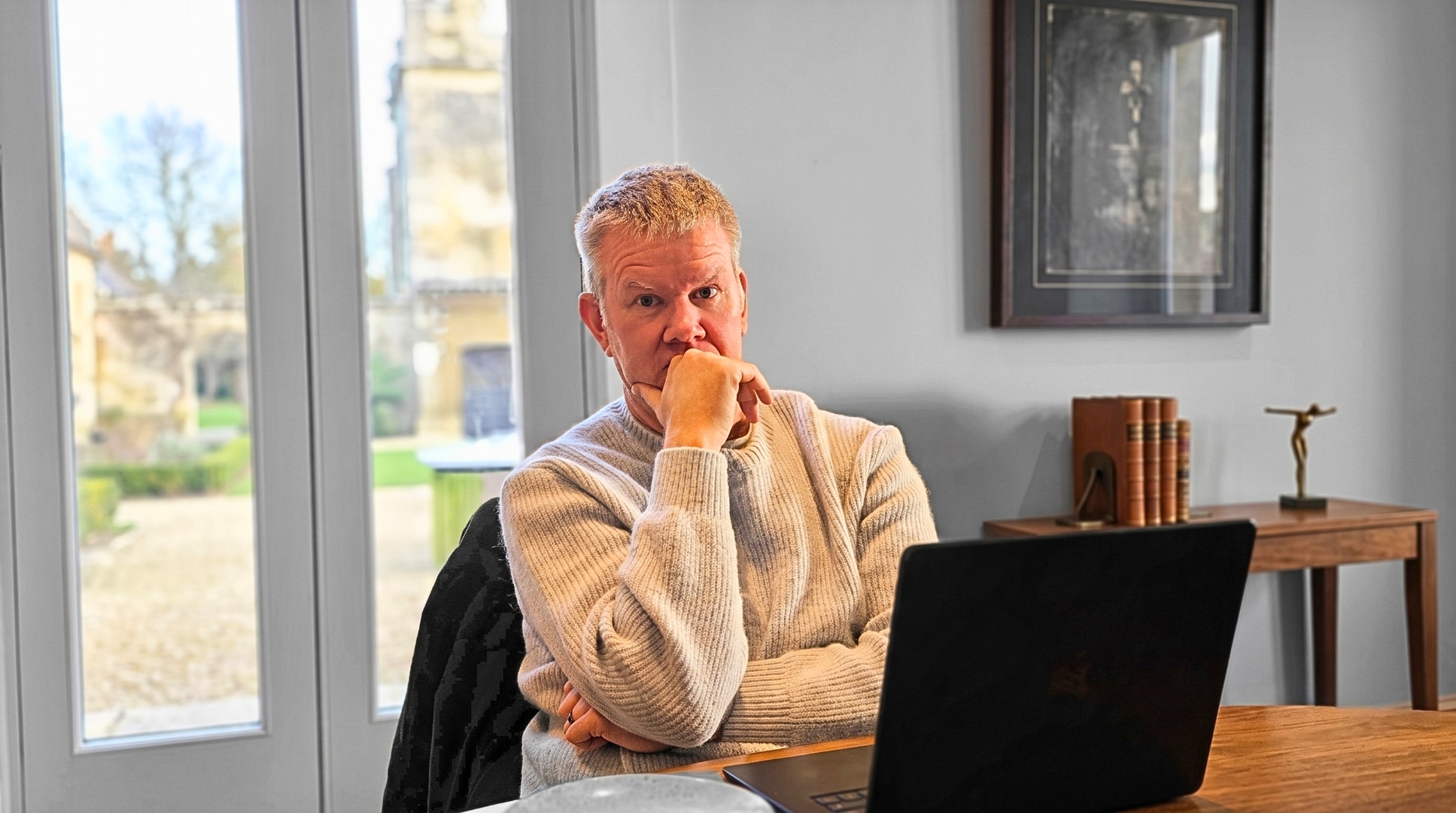 Craig at his desk, contemplative