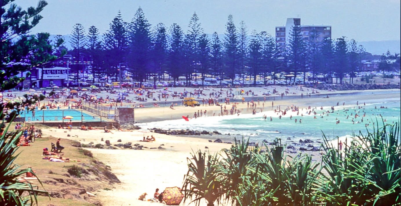 Burleigh Heads beach in 1978, surf club, ocean pool, Norfolk pines and crowds along the sand