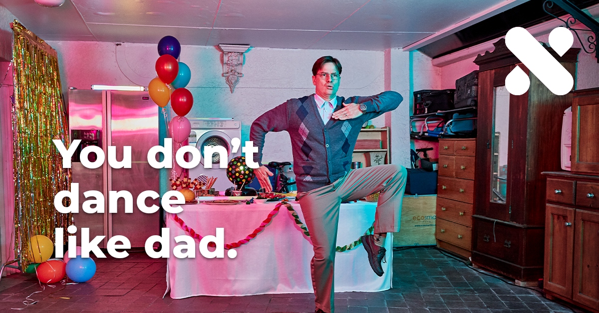 Xinja 'You don't dance like dad' campaign visual, a man dancing in a decorated room, with the Xinja logo